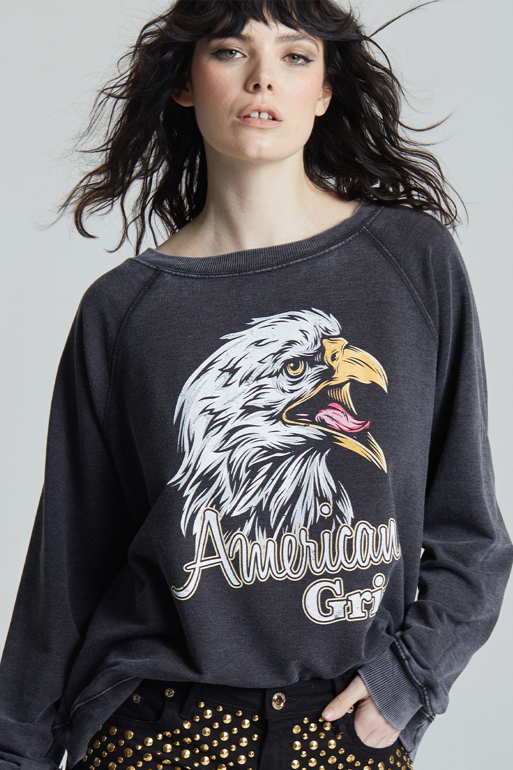 Black oversized 'American Grit' sweatshirt with a bald eagle graphic and 'American Grit' text.