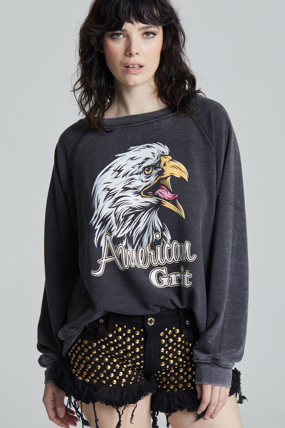 Black oversized 'American Grit' sweatshirt with a bald eagle graphic and 'American Grit' text.