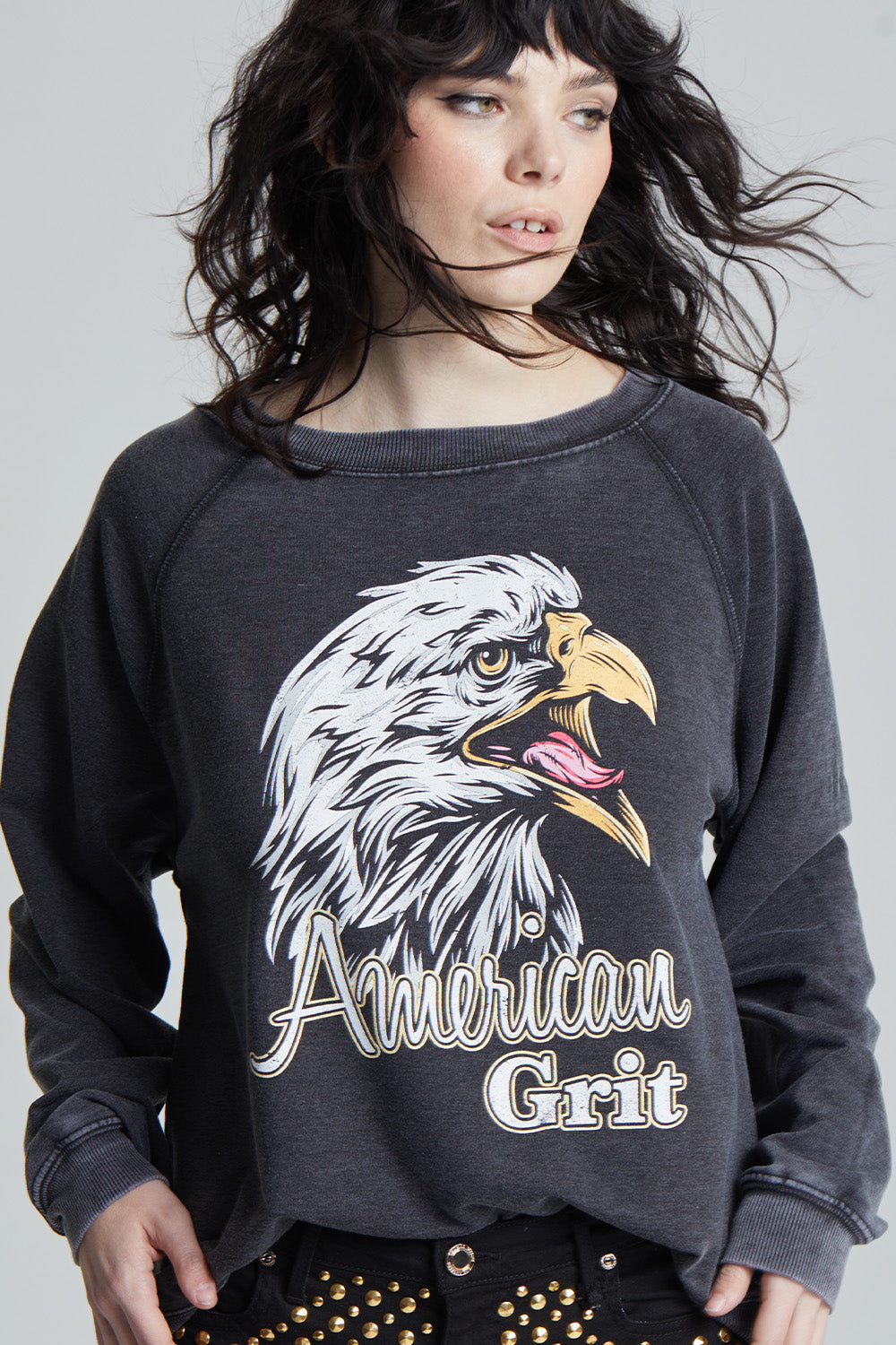 Black oversized 'American Grit' sweatshirt with a bald eagle graphic and 'American Grit' text.